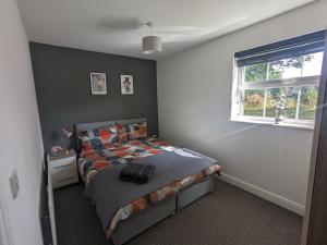 a bedroom with a bed and a window at Superb Modern Apartment, FREE Secure Parking! in Allesley