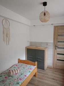 a bedroom with a bed and a wooden floor at Agroturystyka u Chlebków in Ochotnica Górna