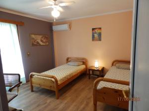 a bedroom with two beds and a window at Muses apartments in Eretria