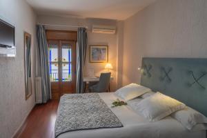 Łóżko lub łóżka w pokoju w obiekcie Hotel Rural Spa Don Juan de Austria