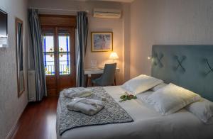 Łóżko lub łóżka w pokoju w obiekcie Hotel Rural Spa Don Juan de Austria