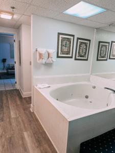 a large bath tub in a bathroom with a mirror at River Place Condos #409 1BD, 2Bath in Pigeon Forge