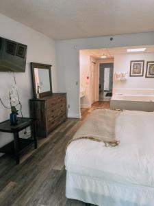 a bedroom with a bed and a dresser and a mirror at River Place Condos #409 1BD, 2Bath in Pigeon Forge