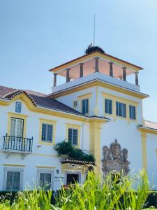 a large white building with a roof at Change The World - Solar de Alvega in Alvega