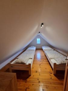 a room with two beds in a attic at Ostoja in Ostrowo