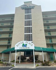 a building with a sign in front of it at River Place Condos #409 1BD, 2Bath in Pigeon Forge