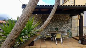 a patio with a table and chairs under a building at Villa Natalia Loft Rural VUT-3846-AS in Llanes