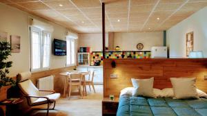 a bedroom with a bed and a table and a kitchen at Villa Natalia Loft Rural VUT-3846-AS in Llanes