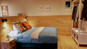 a bedroom with a bed with a wooden headboard at Villa Natalia Loft Rural VUT-3846-AS in Llanes