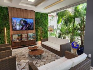 a living room with a couch and a tv at Hotel Appel in Santa Maria