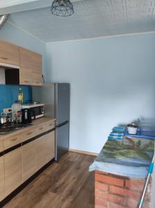 a kitchen with stainless steel appliances and wooden cabinets at Bluci seksti in Seksti