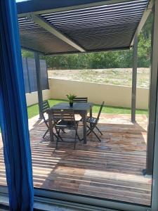 a patio with a table and chairs on a deck at Villa du soleil in Les-Pennes-Mirabeau +15 photos