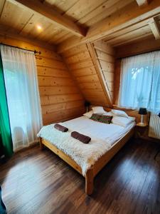 a bedroom with a bed in a wooden cabin at U Dziadka in Chochołów