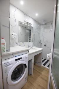 a washing machine in a bathroom with a mirror at Korca Luxury Apartments & Rooms in Korçë +31 photos