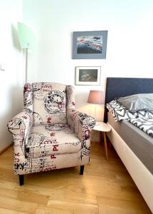 a bedroom with a chair and a bed at Apartmán u lesa, Srní 119 in Srní