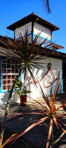 a building with two potted plants in front of it at Casa Sal in Paraty