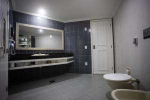 a bathroom with a sink and a toilet and a mirror at Hotel Show Adult Only in Rio de Janeiro