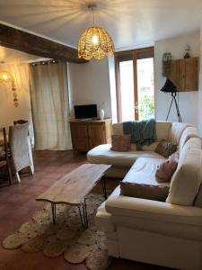 a living room with a couch and a table at le refuge de Majèle 