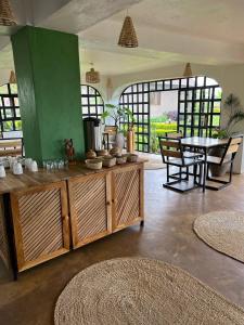 a living room with a table and a table and chairs at Heart and Soul Lodge in Karatu