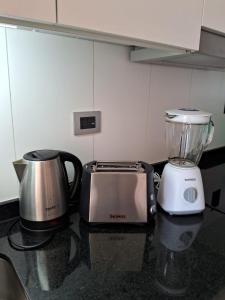 a kitchen with a blender and a toaster on a counter at Nuevo y Cómodo depto tipo Estudio in Valdivia