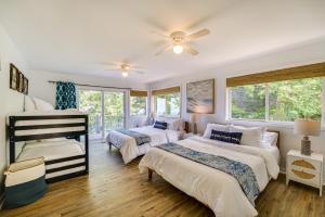 a bedroom with two beds and a ceiling fan at Private Beachfront Lake Michigan Rental with Kayaks in Pentwater