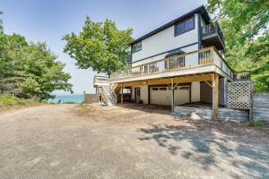 a large house with a balcony and a driveway at Private Beachfront Lake Michigan Rental with Kayaks in Pentwater
