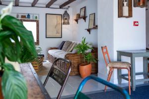 a living room with a couch and a table and chairs at Hostal Boutique Es Menut in Tossa de Mar