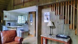 a kitchen with wooden walls and a chair in a room at 157SL peaceful forest retreat in Franconia
