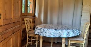 a table with two chairs and a table with a blue and white at CHARLOTTE LA ROULOTTE in Grosbreuil