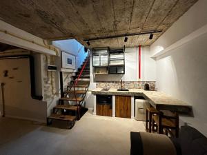 a kitchen with a staircase leading up to a loft at Ego HOME in Cluj-Napoca