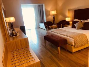 pokój hotelowy z łóżkiem, stołem i krzesłami w obiekcie Stella Beach Resort & Spa, Makadi Bay w mieście Hurghada