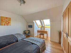 a bedroom with two beds and a desk at Lurach House - Ukc6791 in Port Appin