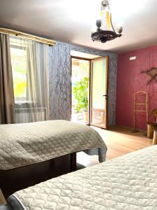 a bedroom with two beds and a window at ARTSIV Guesthouse in Dilijan