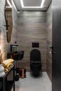 a bathroom with a black toilet and a sink at Sunshine Villa in Nafplio