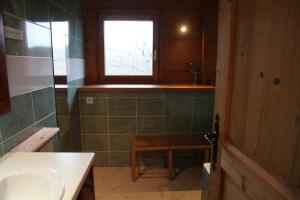 a bathroom with a sink and a window at Le Cro-Bidou in Bernex