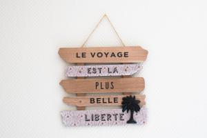 een houten bord met de tekst le voyage britilia plus bills bella bella bij Maison cosy 4chambres 3SDB proche toute commodité in Croix
