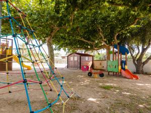 a park with a playground with a swing at Camping Cambrils Caban in Cambrils