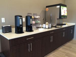 a kitchen counter with a coffee maker on it at Meridian Inn & Suites Lloydminster in Lloydminster