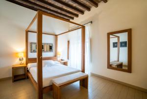 a bedroom with a four poster bed and a mirror at YIT Abentofail in Guadix