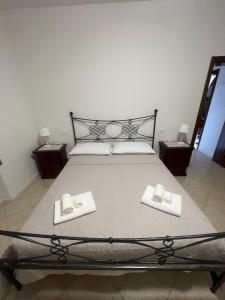 ein Schlafzimmer mit einem Bett mit zwei Hausschuhen darauf in der Unterkunft Appartamento Sunflower in Viareggio