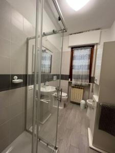 a bathroom with a shower and a sink and a toilet at Appartamento Sunflower in Viareggio