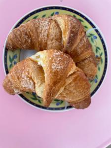 two croissants on a plate on a table at B&B Thérèse 13 in Ginosa Marina