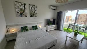 a bedroom with a white bed and a large window at Vaiana in Aguadulce