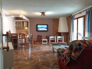 a living room with a couch and a dining room at Muses apartments in Eretria