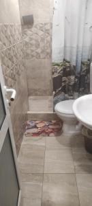 a bathroom with a shower with a toilet and a sink at Violeta 7 Guest House in Nesebar