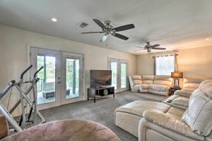 a living room with couches and a flat screen tv at Spacious Family Home on Lake Marion with Boat Ramp! 