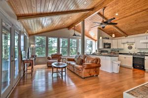 a living room with leather furniture and a kitchen at Spacious Family Home on Lake Marion with Boat Ramp! 