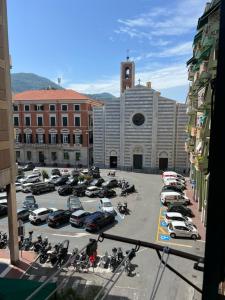a parking lot with cars and motorcycles in a parking lot at speZialhouse - Centro Storico & Cinque Terre in La Spezia