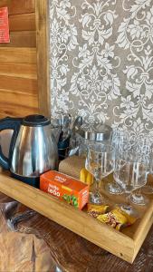 a tray with glasses and a tea pot on a table at Cabanas Por do Sol in Urubici +4 photos