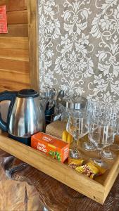a tray with glasses and a tea pot on a table at Cabanas Por do Sol in Urubici